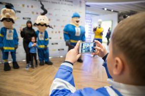 People take pictures with the symbols of the World Championship in hockey