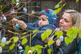 Boy hangs Easter Egg