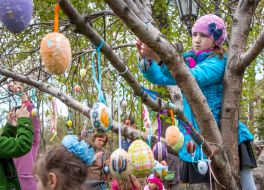 Easter Egg girl hangs on a tree