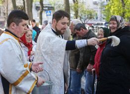 The priest consecrates Easter baskets