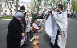 The priest consecrates Easter baskets