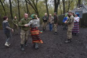 Volunteers dance with the military