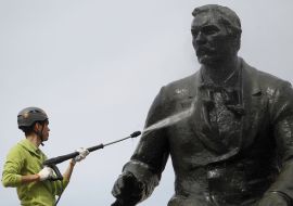 Worker washes monument to Nikolai Lysenko