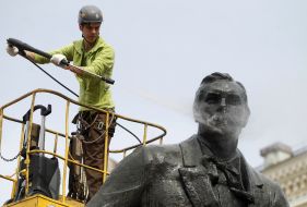 Worker washes monument to Nikolai Lysenko