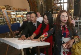 Foreigners touching icons