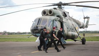 Law enforcement officials accompanying the detained former head of the bus