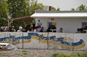 People at the checkpoint of entry and exit "Novotroitskoe"