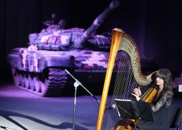 Musician on the background of the tank