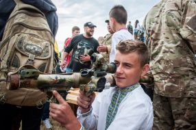 The boy in the embroidery looks at the gun