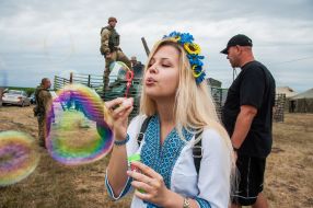 The girl in vyshyvanka pours soap bubbles