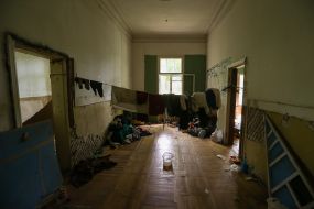 Одежда на веревке в одном из полуразрушенных зданий