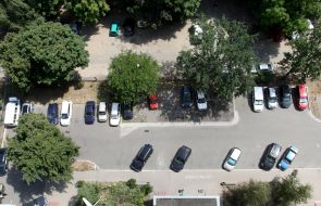 Yard of one of the houses with parked cars