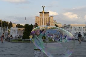 A boy near a huge soap bubble