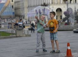 Children near a huge soap bubble
