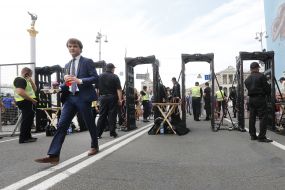 People go through a metal detector frame
