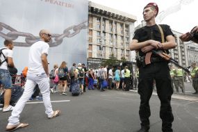 People go through a metal detector frame