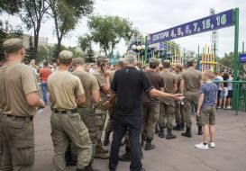 The troops stand in front of the stadium