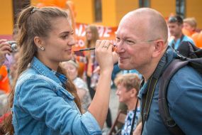 The girl is drawing a man freckles