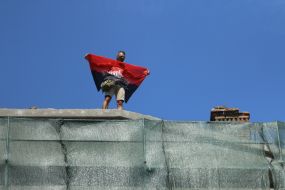 Participant of the meeting on the roof of the house with one wall