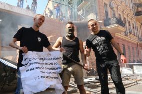 Participants of the rally are photographed with a poster