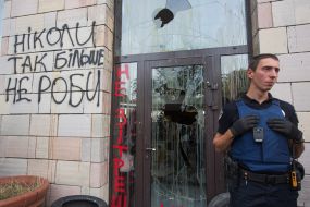 Police near the broken door of the store "Emporium"