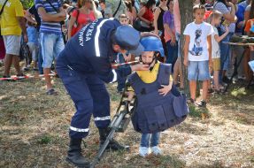 Rescuer helps the boy to wear body armor