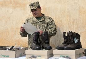The soldier checks the shoes