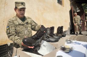 The soldier checks the shoes