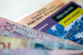 Money and bank card on the pension certificate