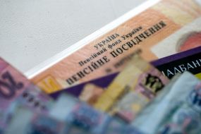 Money and bank card on the pension certificate