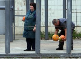 A zoo employee holds a pumpkin