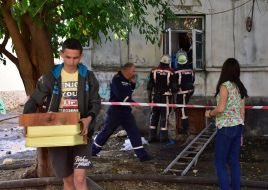 Employees of the Department of Emergency Situations take out the surviving items