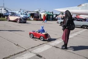 The boy rides a child electric vehicle