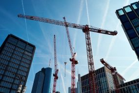 Cranes near skyscrapers