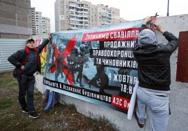 Participants of the rally against the construction of gas stations hang a poster