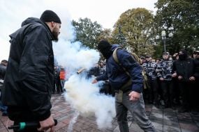 An activist throws a smoke bomb