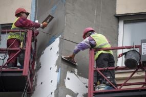 Workers warm the apartment building