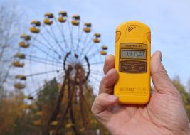 Dosimeter on the background of a Ferris wheel in Pripyat