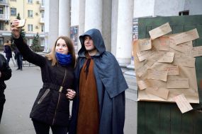 A girl makes a selfie with a man in a raincoat