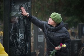 Woman near the grave of the deceased ATO participant