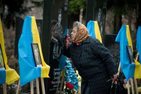 Woman near the grave of the deceased ATO participant