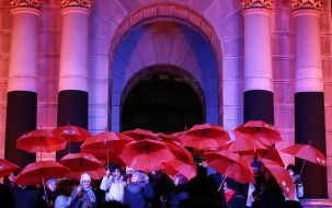 The participants of the flashmob hold umbrellas