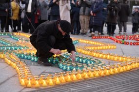 Люди ставят лампадки