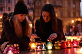 Люди ставят лампадки