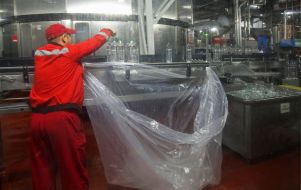 Worker sorts plastic bottles