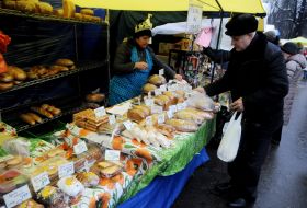 A man buys a loaf at the fair