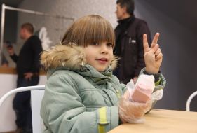 Хлопчик тримає шматок ковбаси