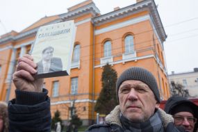 The man holds the book of Mikheil Saakashvili