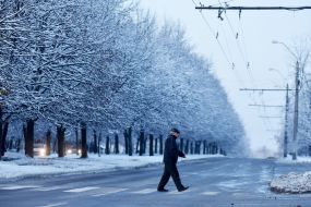 The man crosses the road