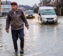 Man and cars on a flooded street
